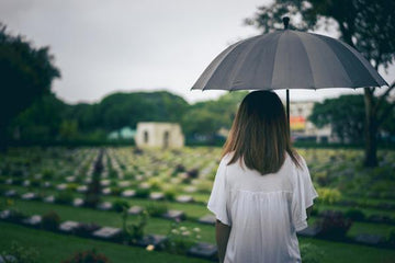A pet owner grieving in a cemetary.