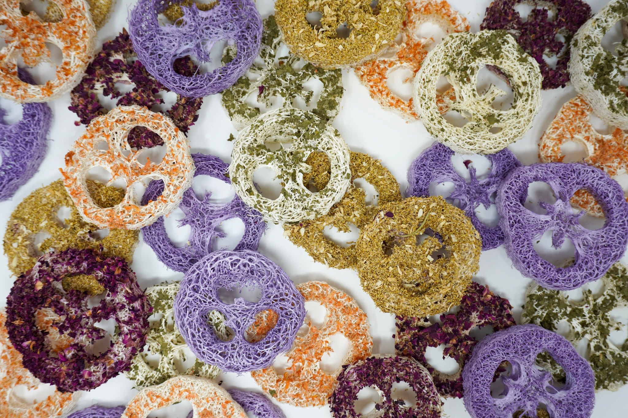 Flavored loofah variety pack scattered in a colorful pile